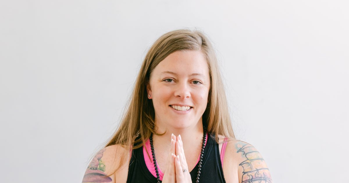 Amanda smiling with her hands together at her heart